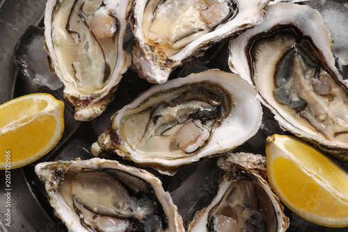 Fresh raw oysters on ice wi...