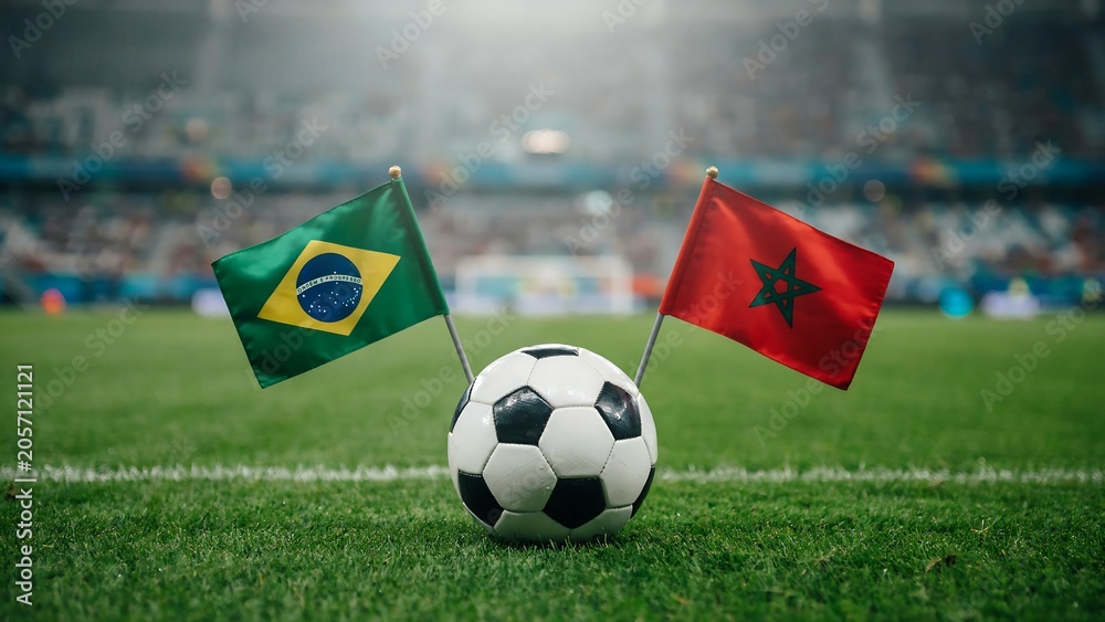 Fototapeta premium Soccer ball on a green grass pitch with Brazil and Morocco national flags for an international match