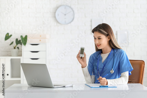 Female doctor with glucomet...