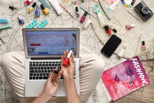 Woman holding nail polish a...