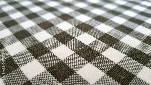 Obraz na plátně Textile background with a rhombic pattern alternating white, black and gray colors