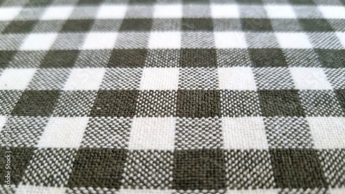 Canvastavla textile background, Checkered fabric with a textured pattern showcases alternating squares in black, white, and gray