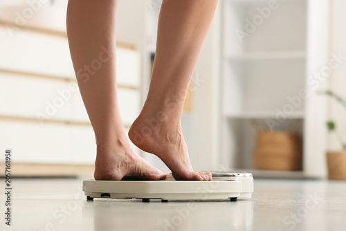 Legs of woman on weight sca...
