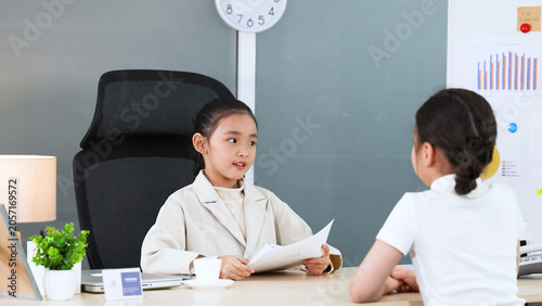 Valokuva Young Asian Girl in Blazer Roleplaying as Executive During Office Meeting