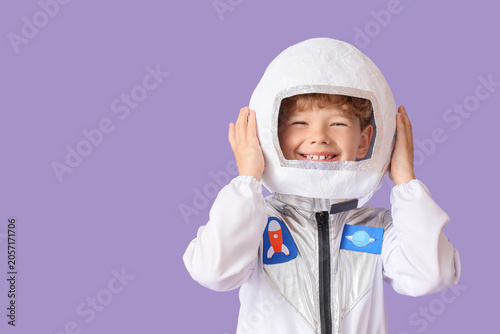 Photos Happy young boy in astronaut costume with helmet smiling, space exploration and