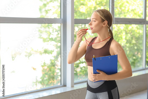 Young female fitness coach ...
