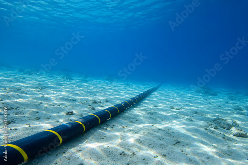 Submarine cable stretching into deep blue sea