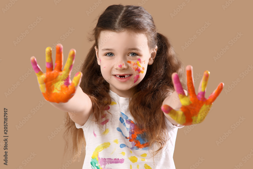 Fototapeta premium Happy young girl with paint-covered hands and face, creative childhood playtime, art and craft activity
