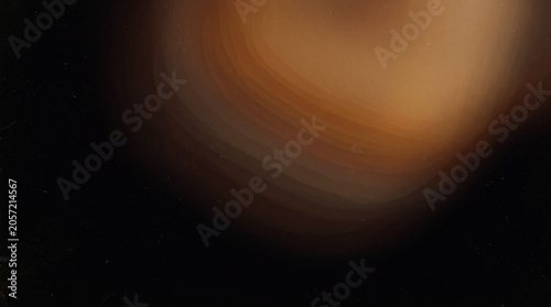 A subtle abstract composition featuring a gentle warm brown light leak blooming softly from the upper corner against a pure solid black background
