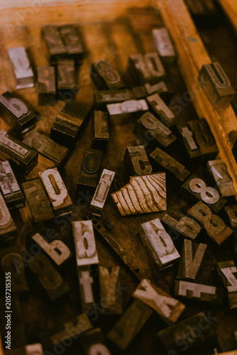 Vintage letterpress type blocks in a wooden tray