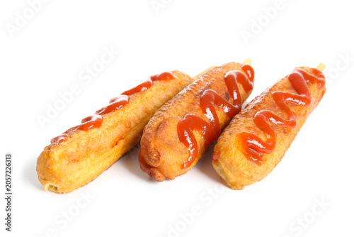 Tasty corn dogs with ketchu...