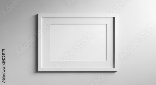 A single horizontal white frame with a mat board hanging on a plain gray wall, providing a clean and simple space for display mockups