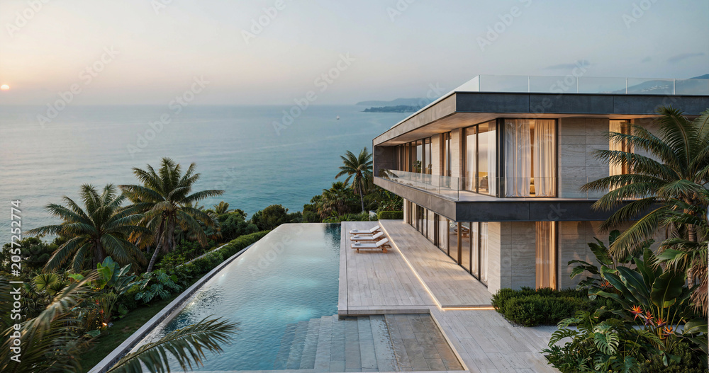 Fototapeta premium Modern luxury villa with infinity pool overlooking the ocean at sunset