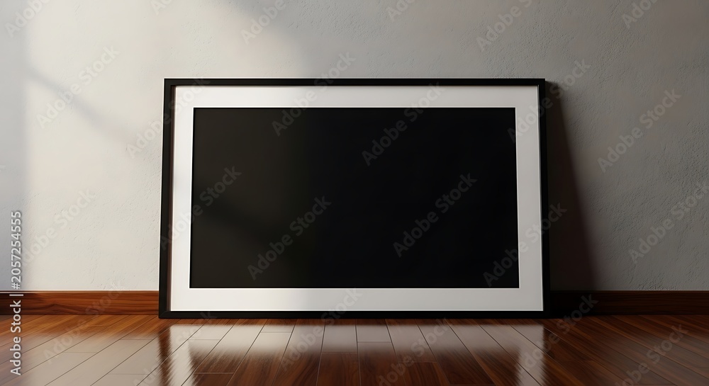 Fototapeta premium Empty black rectangular frame mockup leaning against a white wall on a polished dark brown wooden floor with soft natural window lighting