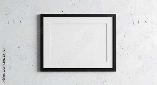 Empty horizontal black frame mockup on a textured light gray concrete wall with a white mat board inside the frame for display