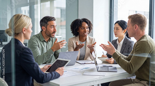 Fotografija Group of multi-ethnic business colleagues actively collaborating during a strategy meeting in a modern office