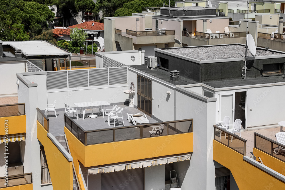 Fototapeta premium Modern residential building rooftops with outdoor terraces and balconies, urban architecture and lifestyle