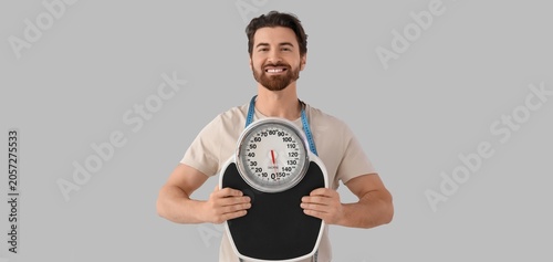 Smiling man holding weight ...