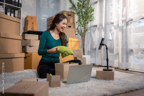 Woman selling clothes online via live stream