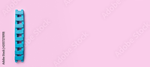 Blue wooden ladder on pink ...