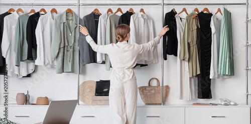 Young woman choosing clothe...