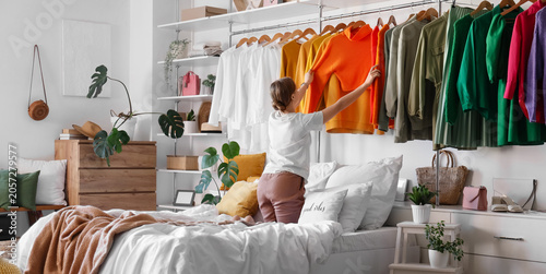 Young woman choosing clothe...