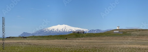 Panoramic view of an Icelandic farm on the Snaefellsnes peninsula with the Snaefellsjokull glacier cap in the background