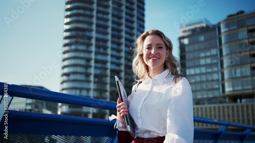 Businesswoman with smartphone in financial district.
