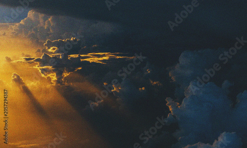 Golden sunset clouds seen from an airplane window