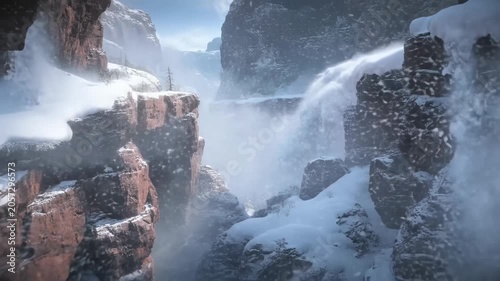 Dramatic winter avalanche cascades over snowy rocky cliffs in mountainous landscape