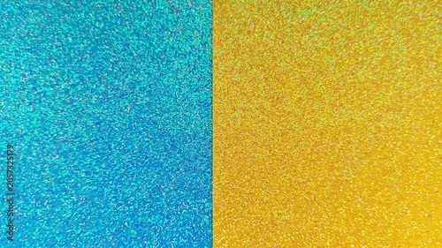 Картината върху платно Defocused shimmering azure blue and golden yellow sequin backdrop divided in half