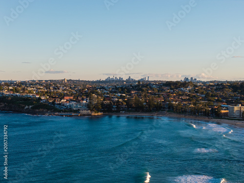 Beautiful aerial view of Sydney beach with skyline on the background.