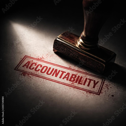 Accountability stamp on paper implies consequences for actions and enforces responsibility with dramatic lighting and vintage wooden seal