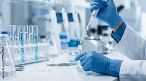Scientist working in laboratory setting carefully.