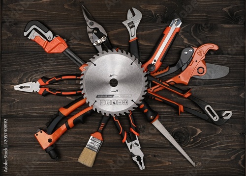 Premium product photography of a modern manual tool set on wood surface. Perfect visual asset for Father's Day greeting cards, hardware retail ads, and male hobby blogs.