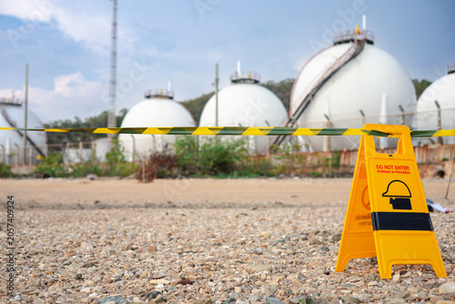 The chemical restricted area is marked with warning signs and hazardous tape during an inspection of hazardous materials at the industrial plant.