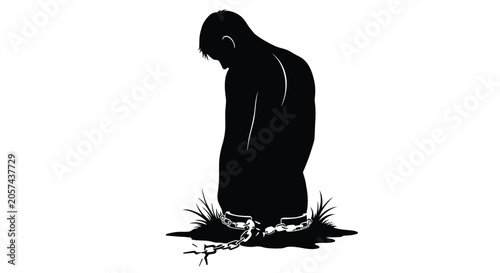 Fotografie silhouette of a man chained and kneeling on the ground