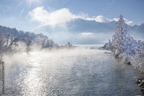 Winter landscape with outflow of the Loisach from the Lake Kochel in front of the Herzogstand 1731m, Kochel am See, Das Blaue Land, Bavarian Alps, Upper Bavaria. Bavaria, Germany