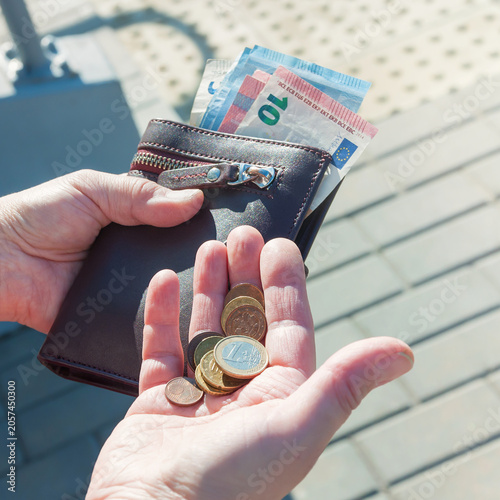 Cuadro en lienzo Leather purse, euro banknotes and coins in female hands, selective focus
