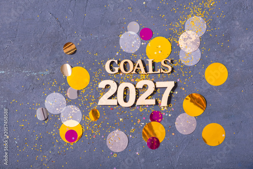 Obraz na plátně Goals for 2027 spread on a table with colorful confetti and decorations around