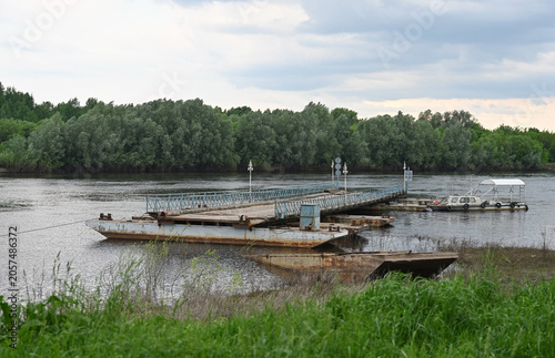 A pontoon bridge spanning a river with banks
