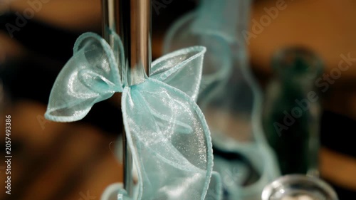A ribbon bow decorates the table at the event. Close-up shots of the decor