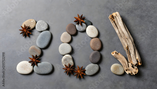 Stones and Wood Elements Forming 201: A creative composition featuring smooth stones, star anise, and driftwood arranged on a textured surface to form the number 201.