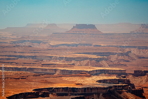 Expansive layered desert canyon landscape with distant mesas