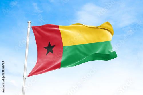Obraz na plátně Guinea Bissau national flag waving against blue sky
