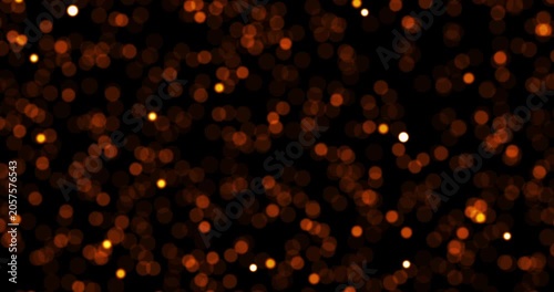 A seamless looping video background displays chaotic bokeh particles moving toward the viewer. The glowing golden dust particles create a magical floating effect against a dark backdrop.