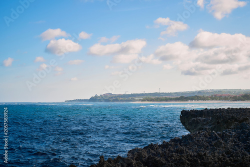 Viewing the sea with its white-capped waves from the island