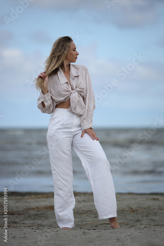 Young Woman Posing on Beach in Striped Shirt