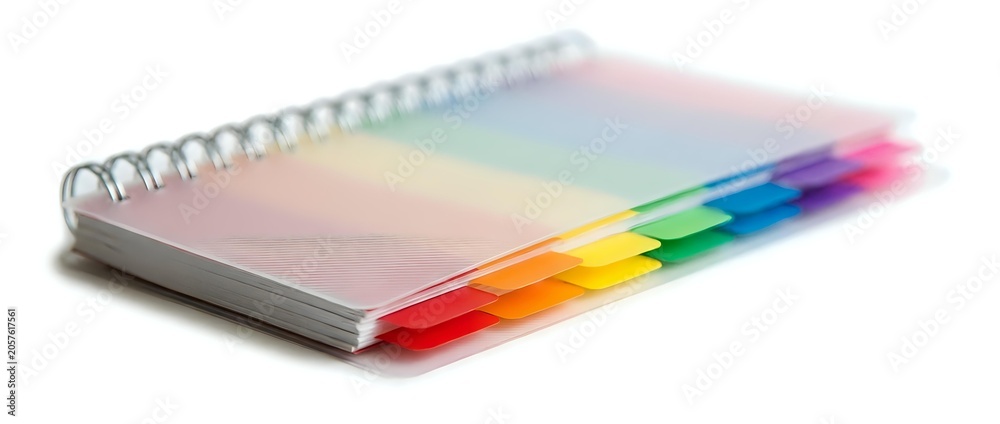 Fototapeta premium Spiral-bound notebook with rainbow gradient pages transitioning from white to vibrant colors, isolated on white background for design, printing, and educational materials.
