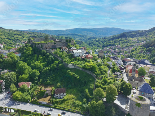 Aerial drone shot of historical Jajce town and medieval fort at top of the hill